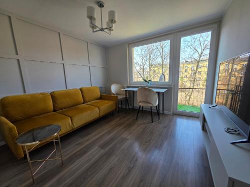 a living room with a couch and a table at Majowy in Siedlce