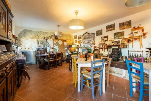 a dining room with tables and chairs in a building at Charming House in Vesime with Shared Pool in Vesime