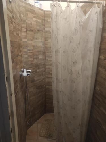 a bathroom with a shower with a shower curtain at Station Backpackers in Budapest