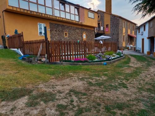 a wooden fence in front of a house at Spacious villa with pool in Empalme de Vilar - 300 m², 8 guests in Vilar