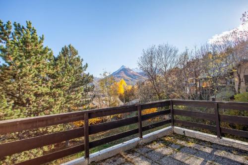 a fence with a mountain in the background at Chalet confortable à Briançon avec vue sur montagne in Briançon