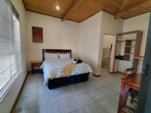 a bedroom with a large bed in a room at The Lantern Porch Guesthouse in Vryburg