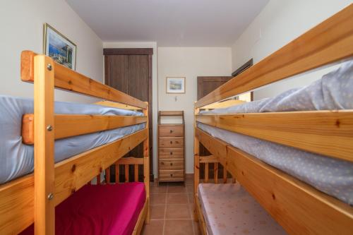 a room with three bunk beds in a house at Inmacanela playa in Isla Canela