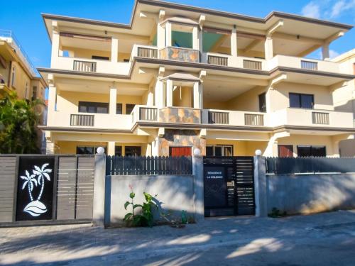 a building with a fence in front of it at Cozy studio in Trou-aux-Biches 35 m² with lovely garden balcony in Trou aux Biches