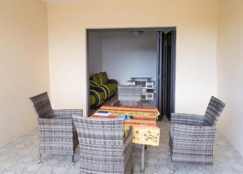 a living room with a table and chairs at Cozy studio in Trou-aux-Biches 35 m² with lovely garden balcony in Trou aux Biches