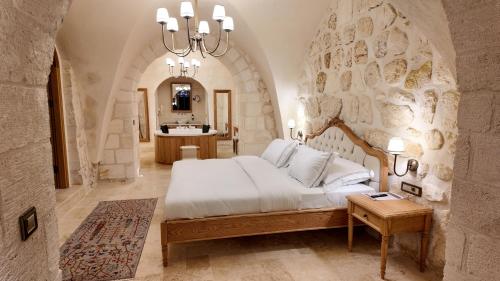 a bedroom with a large bed and a mirror at Shamas Hotel in Midyat