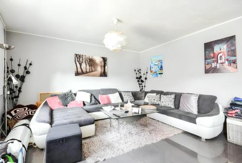 a living room with a couch and a table at Spacious House in Tongeren in Tongeren