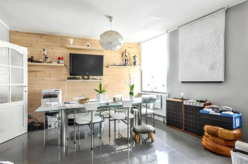 a dining room with a table and chairs and a tv at Spacious House in Tongeren in Tongeren