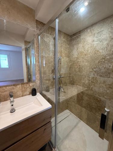 a bathroom with a sink and a shower at Premium Apartment with Private Jacuzzi in Mougins