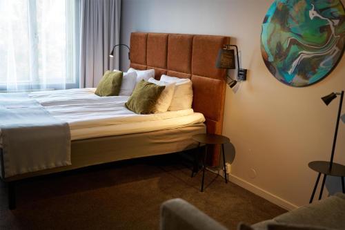 a bedroom with a large bed with a headboard at Scandic Laholmen in Strömstad