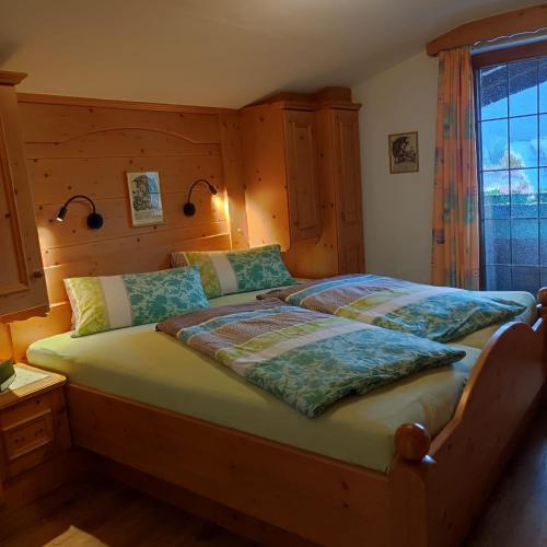 a bedroom with a large bed in a room at Pretzners Ferienwohnungen in Reit im Winkl