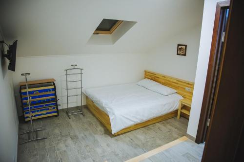 a small bedroom with a bed and a ladder at Ungweiser in Uzhhorod