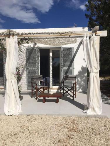 a gazebo with a chair and a swing at Comfortable House in Formentera with Garden and Terrace in Sant Francesc Xavier