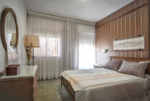 a bedroom with a large bed and a mirror at Charming Villa in Vitigudino with Private Pool in Vitigudino