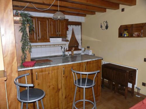 a kitchen with two bar stools and a counter top at Charming Chalet in Viella, Mountain View in Vielha