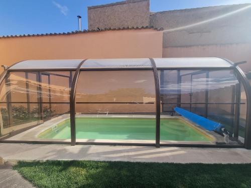 aulating pool with a glass enclosure on a house at Charming villa in Pajares de la Lampreana with private pool in Pajares de la Lampreana