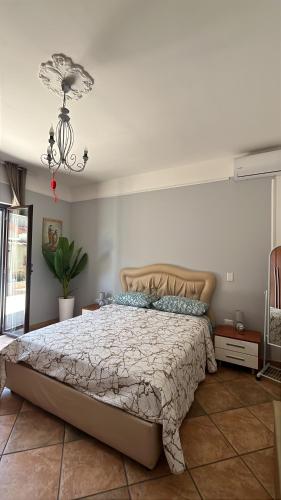 a bedroom with a bed and a chandelier at Bed and Breakfast Medaglia D'oro in Marcianise
