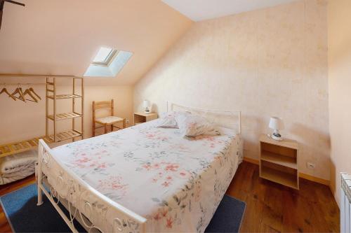a bedroom with a bed and a skylight at Chez Pauline in Massangis