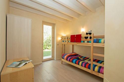 a room with two bunk beds and a table at Villa Marina Moniga Private Pool in Moniga