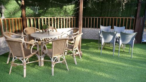 a patio with a table and chairs on the grass at Elegant Villa in Archena + Private Pool in Archena