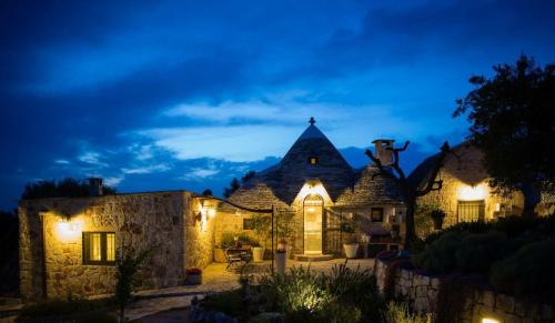 an exterior view of a house at night at Spacious Villa with Private Pool in Castellana Grotte in Alberobello