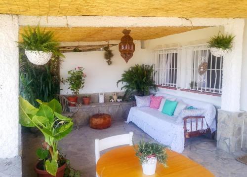a patio with a couch and a table at Charming House in El Chaparral in EL Chaparral