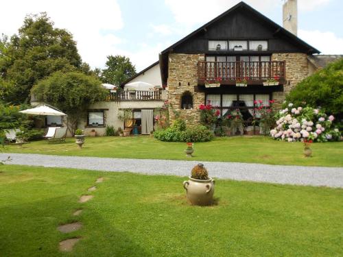 a large house with a vase in the yard at Villa spacieuse à Haut-de-Bosdarros avec piscine privée in Haut-de-Bosdarros