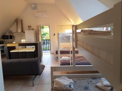 a room with a staircase with bunk beds in it at Villa charmante à Saint-Benoît avec piscine privée in Saint-Benoît