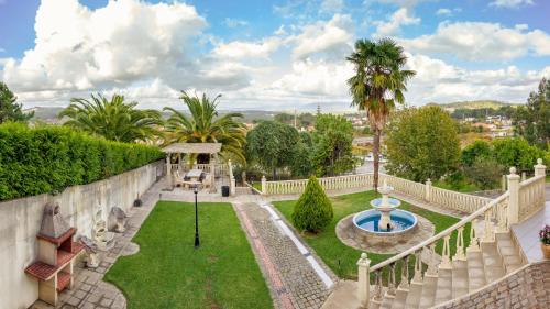 an estate with a garden with a fountain at Majestic Manor in Valença with private pool in Valença