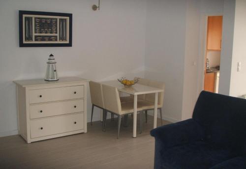 a living room with a small table and a chair at Charming Apartment in Troia, Garden View, 60 sqm in Troia