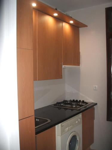 a kitchen with a stove and a washing machine at Charming Apartment in Troia, Garden View, 60 sqm in Troia