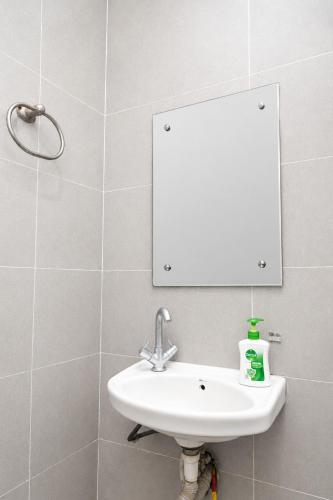 a bathroom with a sink and a mirror at Fly Inn in Guwahati