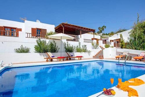 a swimming pool in front of a house at Modern Villa in Nazaret with Private Pool in Nazaret