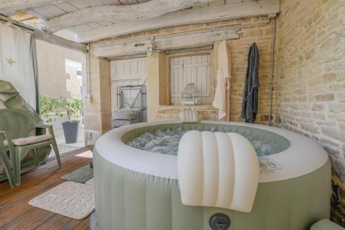 a large bath tub in a room with at Les loulous in Arrentières