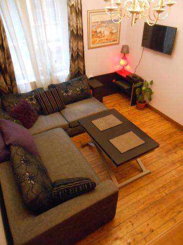 a living room with a couch and a table at Spacious House in Central Sofia with Garden in Sofia