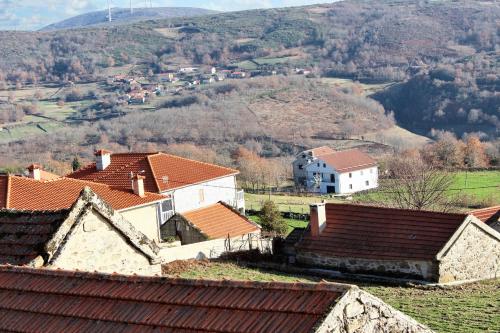 a group of houses with mountains in the background at Charming House in Paredes do Rio with Mountain View in Paredes do Rio