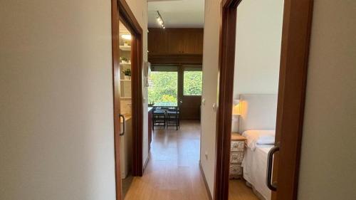 a hallway with a room with a bed and a table at AP TXALUPA II in Barro de Llanes