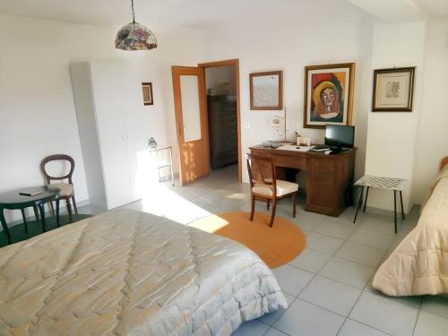 a bedroom with a bed and a desk with a computer at Charming Apartment in Vibo Valentia with Terrace, 60 m² in Vibo Valentia