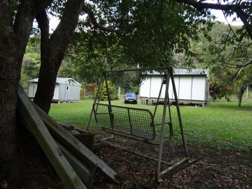 a swing set under a tree in a yard at Bungalow Charmant à Pointe-Noire in Pointe-Noire