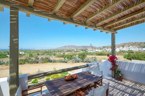 a balcony with a table and a view of the beach at Spacious house with sea view in Ag. Arsenios, garden in Glinádhon