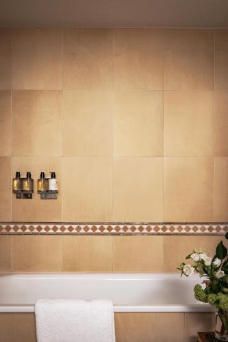 a bathroom with a bath tub in a room at Nutfield Priory Hotel & Spa in Redhill