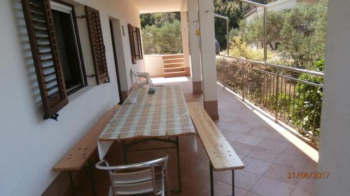 a table and chairs on the balcony of a house at Charming Apartment in Gdinj + Garden in Gdinj