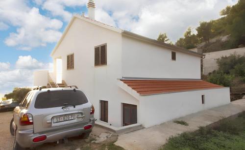 a car parked in front of a white church at Charming Apartment with Sea View, Gdinj, 70 m², Garden in Gdinj