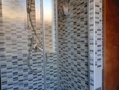 a shower with blue and gray tiles in a bathroom at Antica Tibur in Tivoli