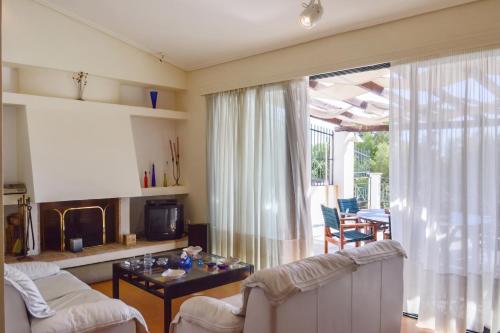 a living room with a couch and a table at Charming Villa with Sea View in Karistos in Karistos