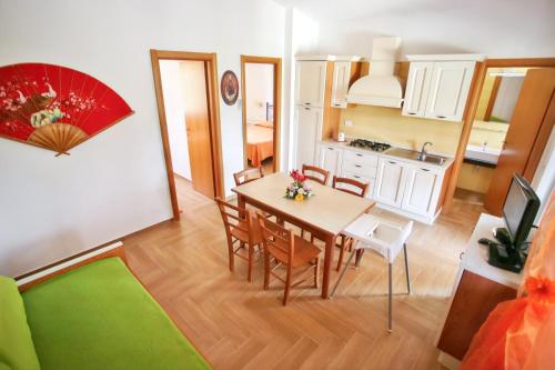 a kitchen and dining room with a table and chairs at Charming House in Vieste with Shared Pool and Terrace in Vieste