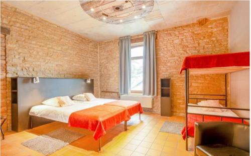 a bedroom with a bed and a loft bed at Spacious villa in Florenville with private pool in Florenville
