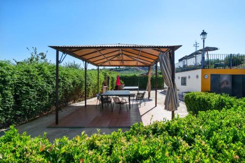 a pavilion with a table and chairs in a garden at Comfortable House in Carcabuey with Private Pool in Carcabuey