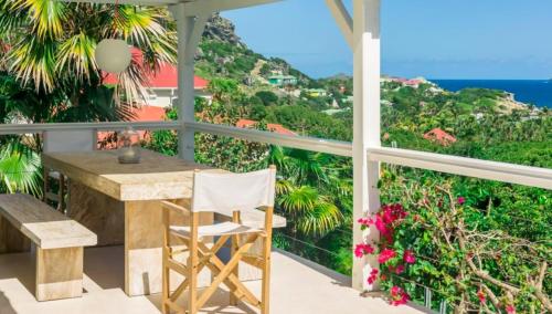 a balcony with a table and a view of the ocean at Heavenly Villa in Gustavia with Private Pool in Gustavia