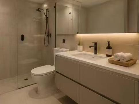 a white bathroom with a toilet and a shower at OMI Collection Broadbeach in Gold Coast
